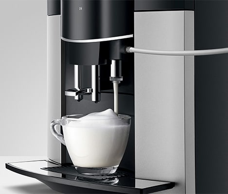 Jura Coffee Maker D6 and a cup of frothed milk