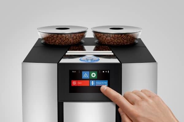 Two cone-shaped bean hoppers and Touchscreen display of the Jura Giga 6 coffee machine 
