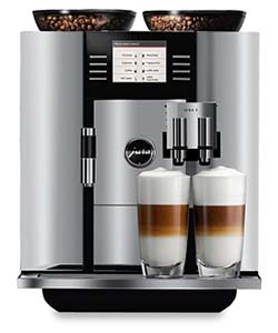 The Jura Giga 5 with full bean hoppers and 2 glasses of specialty coffee below its spouts