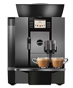 The Jura Giga W3 with two cups of coffee below its spouts