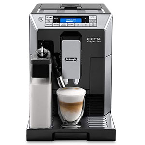 De’Longhi Eletta Digital Superautomatic  with a milk carafe and glass under its coffee spouts 