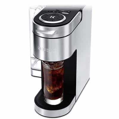 Keurig K Supreme Plus in stainless steel with a glass filled with cold brew under its spout