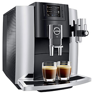 Jura E8 Espresso Machine in black and chrome and with a colored display and two full espresso glasses on the drip tray
