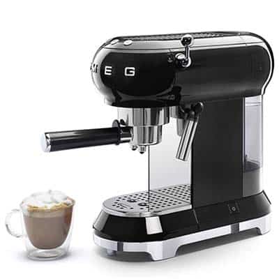 Smeg 50s Retro Style Espresso Coffee Machine in black with a small cup of cappuccino beside it