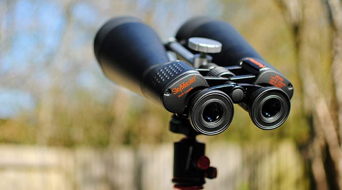 SkyMaster binoculars with multi-coated optics, mounted on a tripod in the backyard