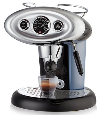 Illy X7.1 iperEspresso Machine with black and chrome exterior and a half-full espresso glass on the drip tray