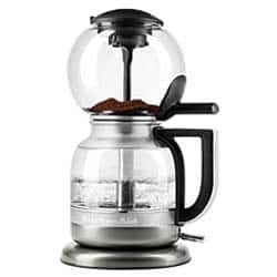 KitchenAid Siphon Coffee Maker with two glass carafes, silver & black components, & ground coffee in the top carafe