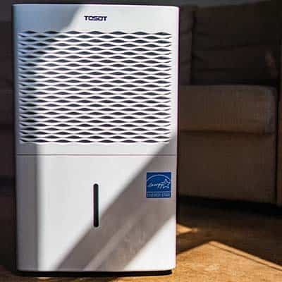 Tosot 50 Pint Dehumidifier in a room with brown floor and sunlight streaming in 