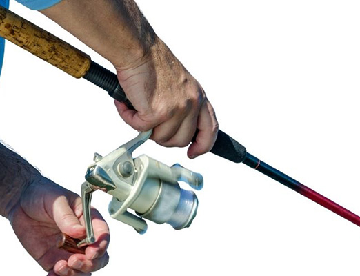 man fishing with a black and red rod and white spinning reel