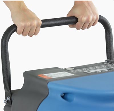Person holding the pull handle of the Dri-Eaz Drizair 1200 Dehumidifier with both hands